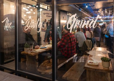 A window view into the ACE Awards, with "The Daily Grind" written on the window.