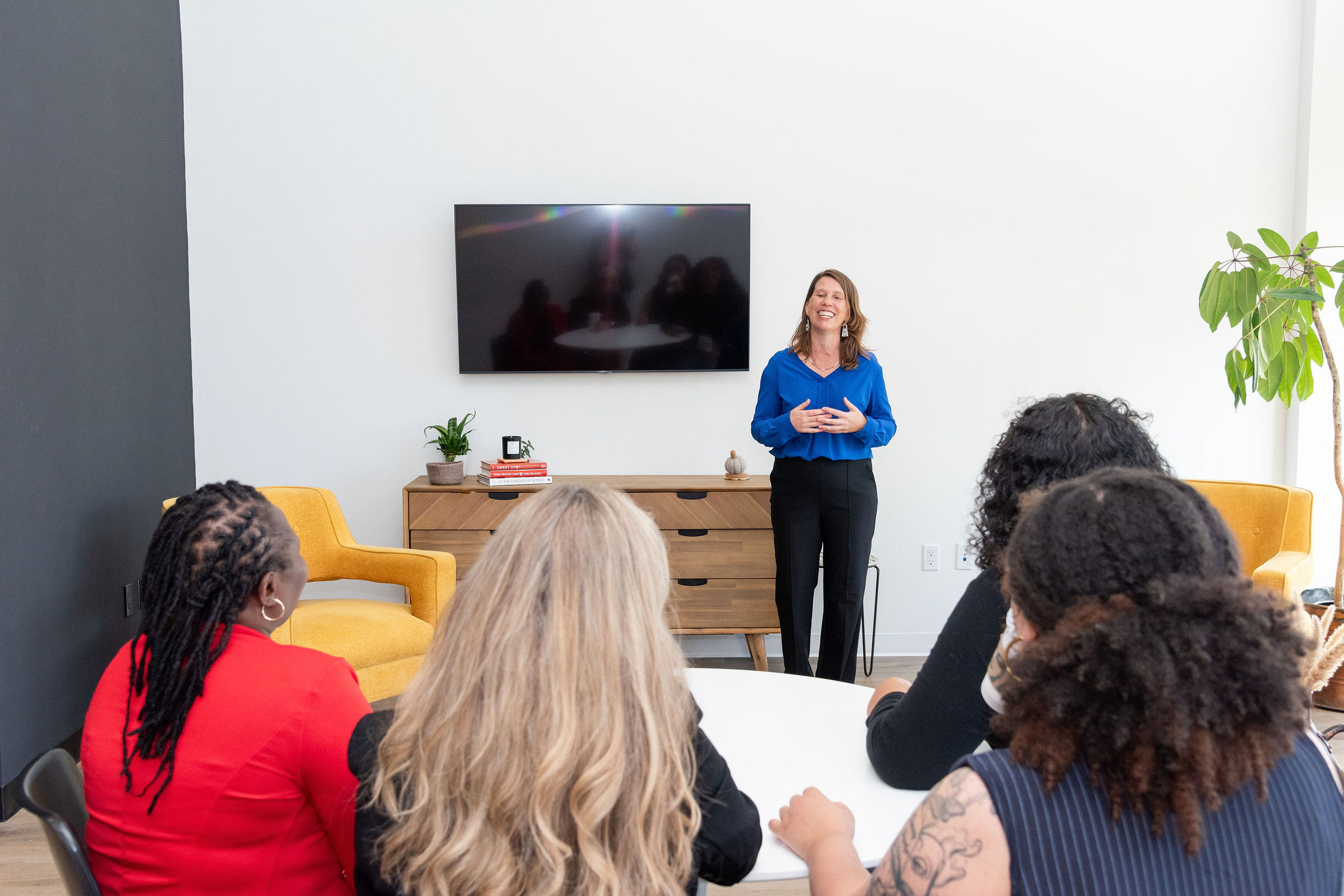 Corrie speaking to a room of people